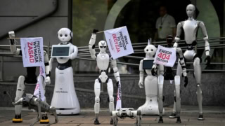 Robots Take To Warsaw Streets To Protest Against Rampant Ai